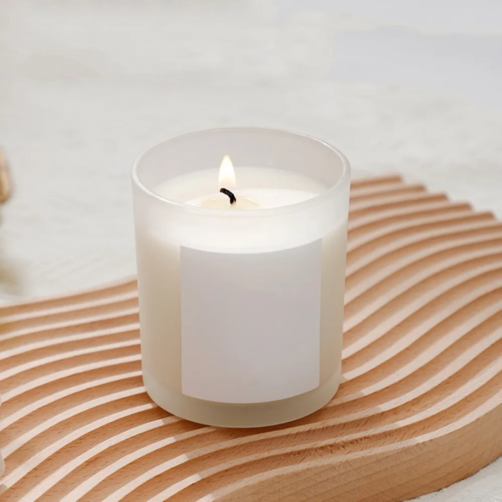 a candle sitting on top of a wooden tray