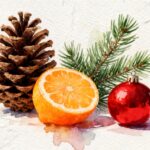 pinecone with green pine needles next to a juicy orange and a christmas decoration